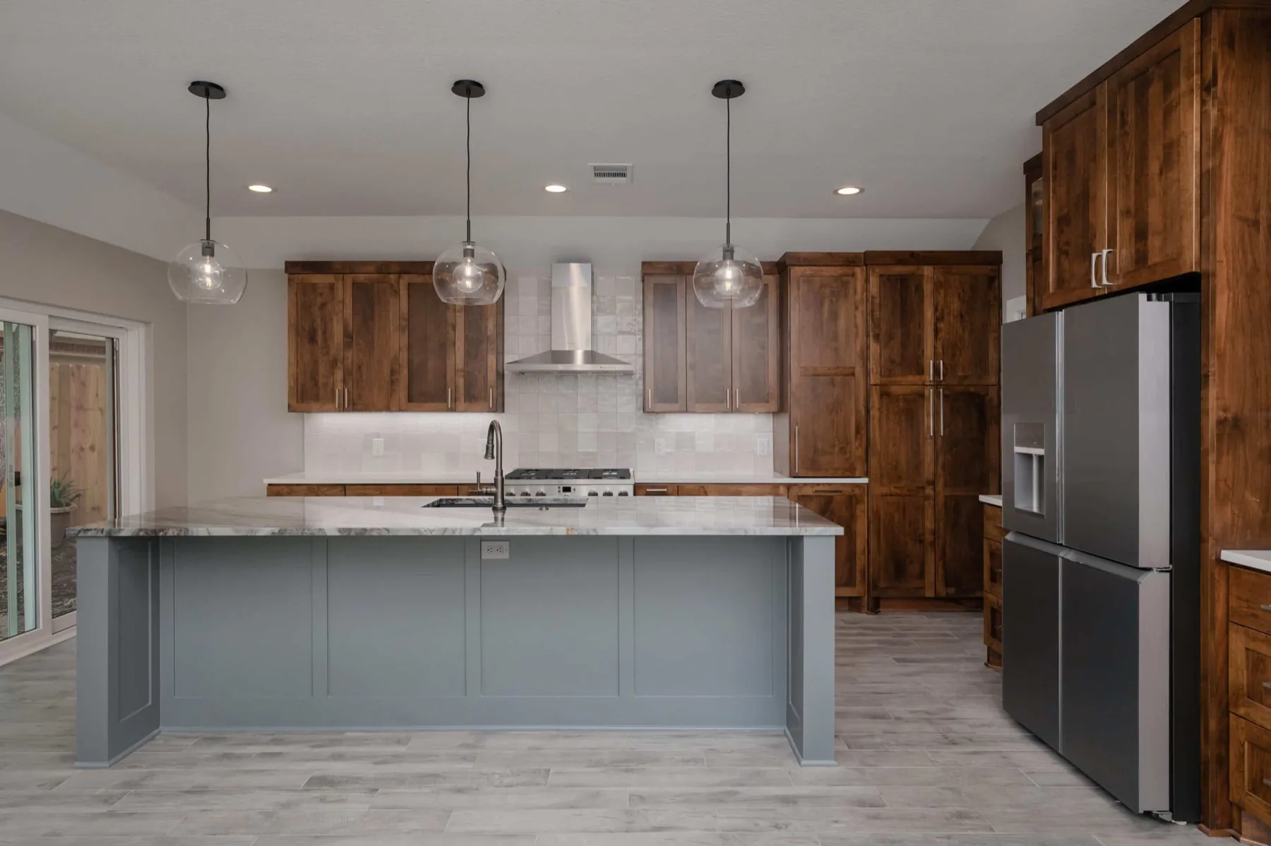 The Circle C complete home remodel kitchen with a grey-blue island