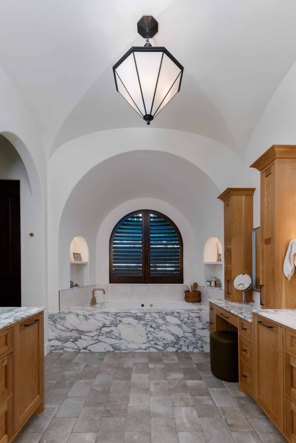 The Spanish Oaks Italian master bath with arched ceilings and marble