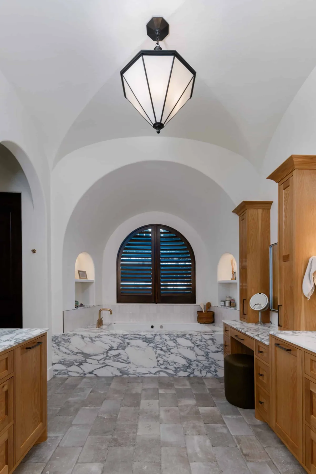 The Spanish Oaks Italian master bath with arched ceilings and marble