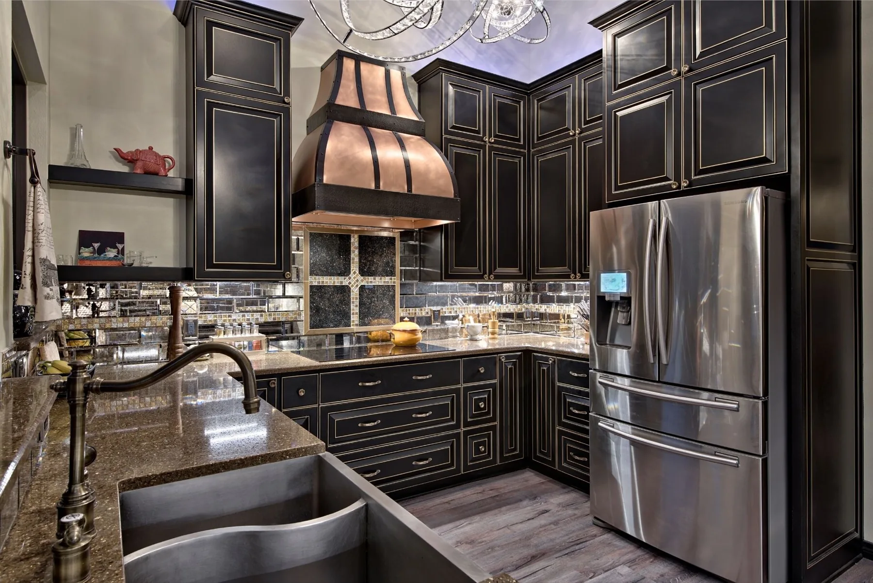 The Great Hills steampunk kitchen renovation with black cabinetry and a copper hood